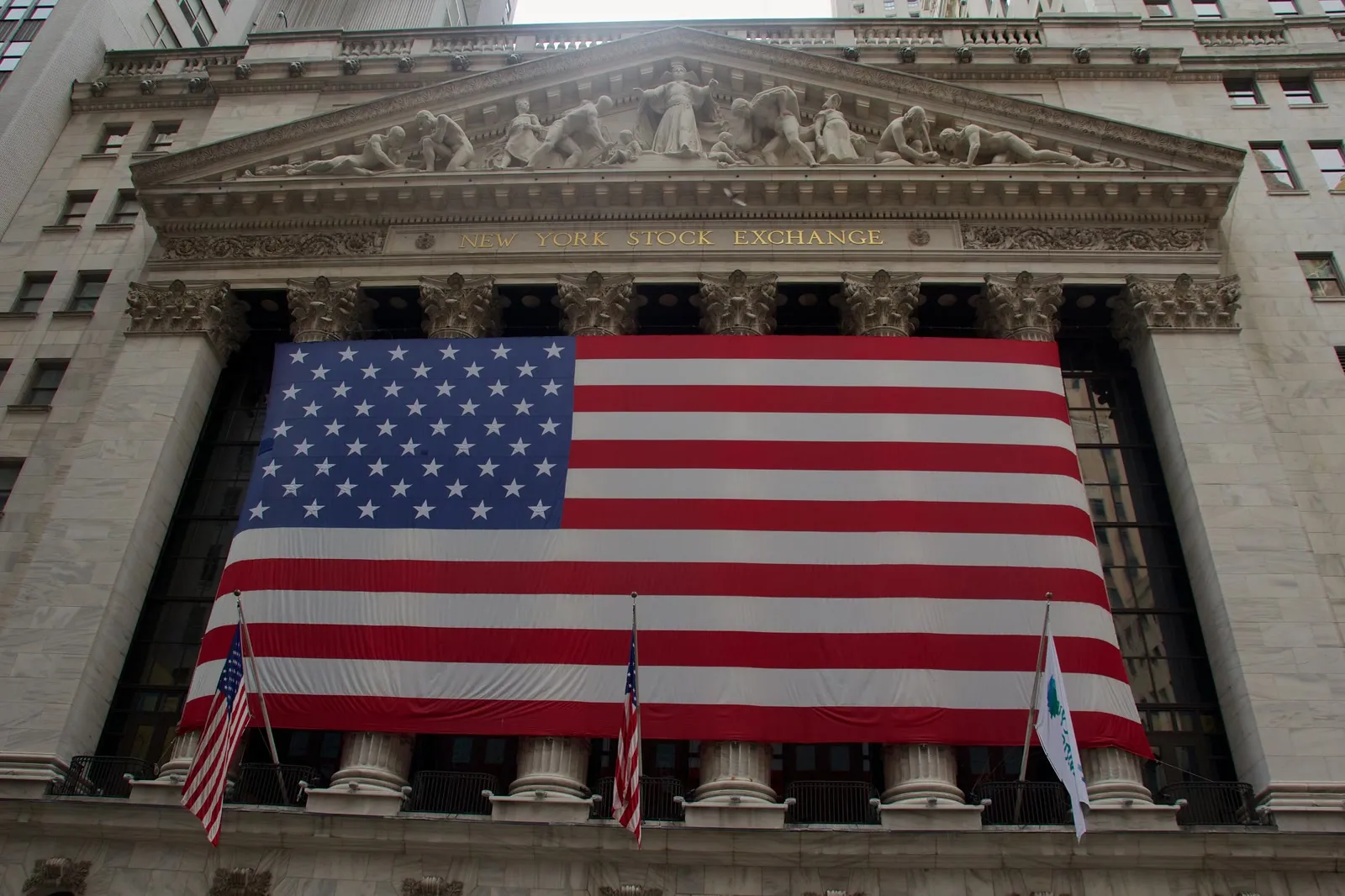 The New York Stock Exchange with a giant American flag